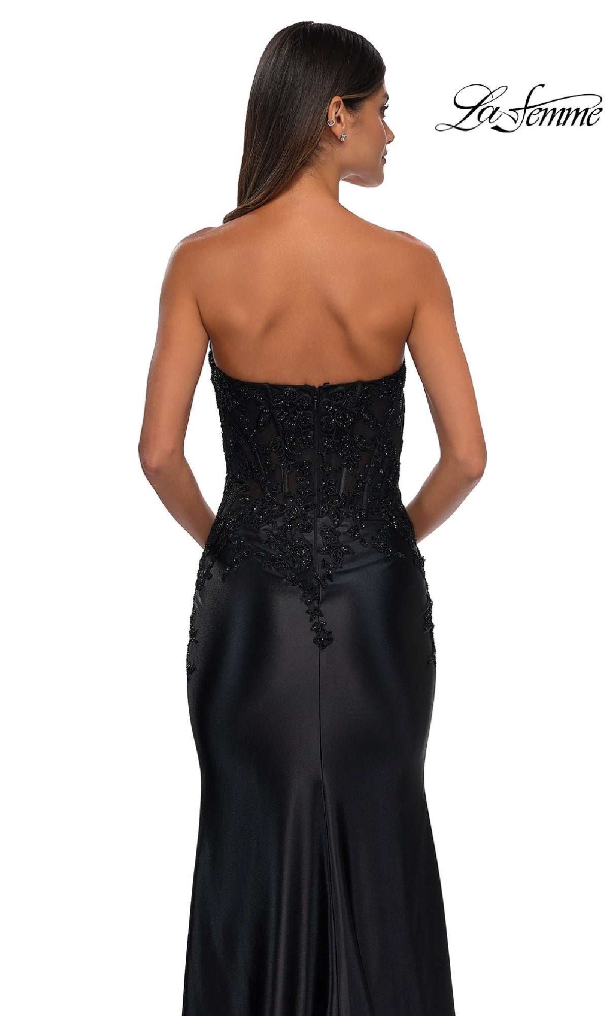 A woman models the La Femme 32582, a tight strapless long prom dress with a beaded bodice and embroidered details, photographed from the back on a white background. The